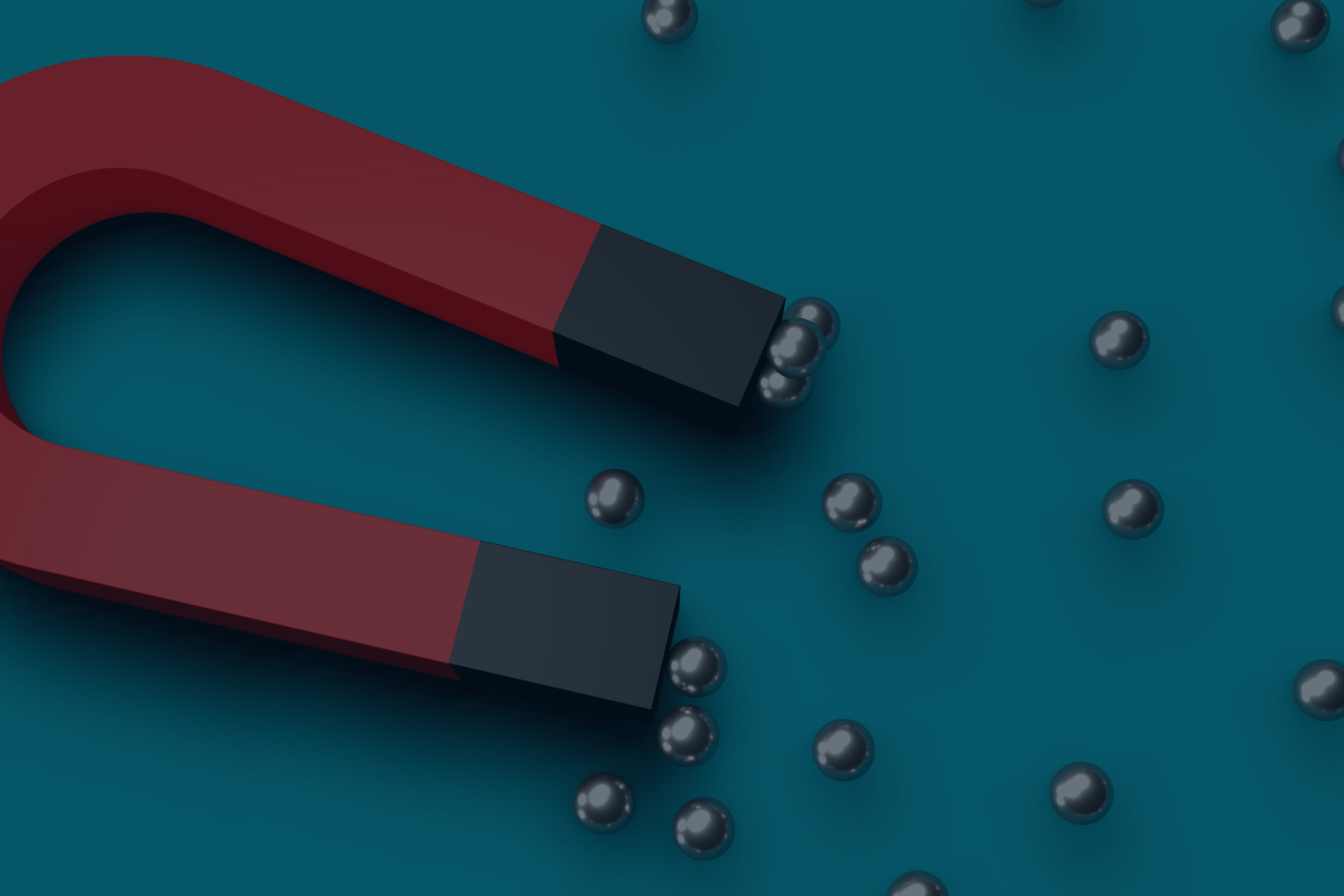 A red horseshoe magnet attracting metal ball bearings